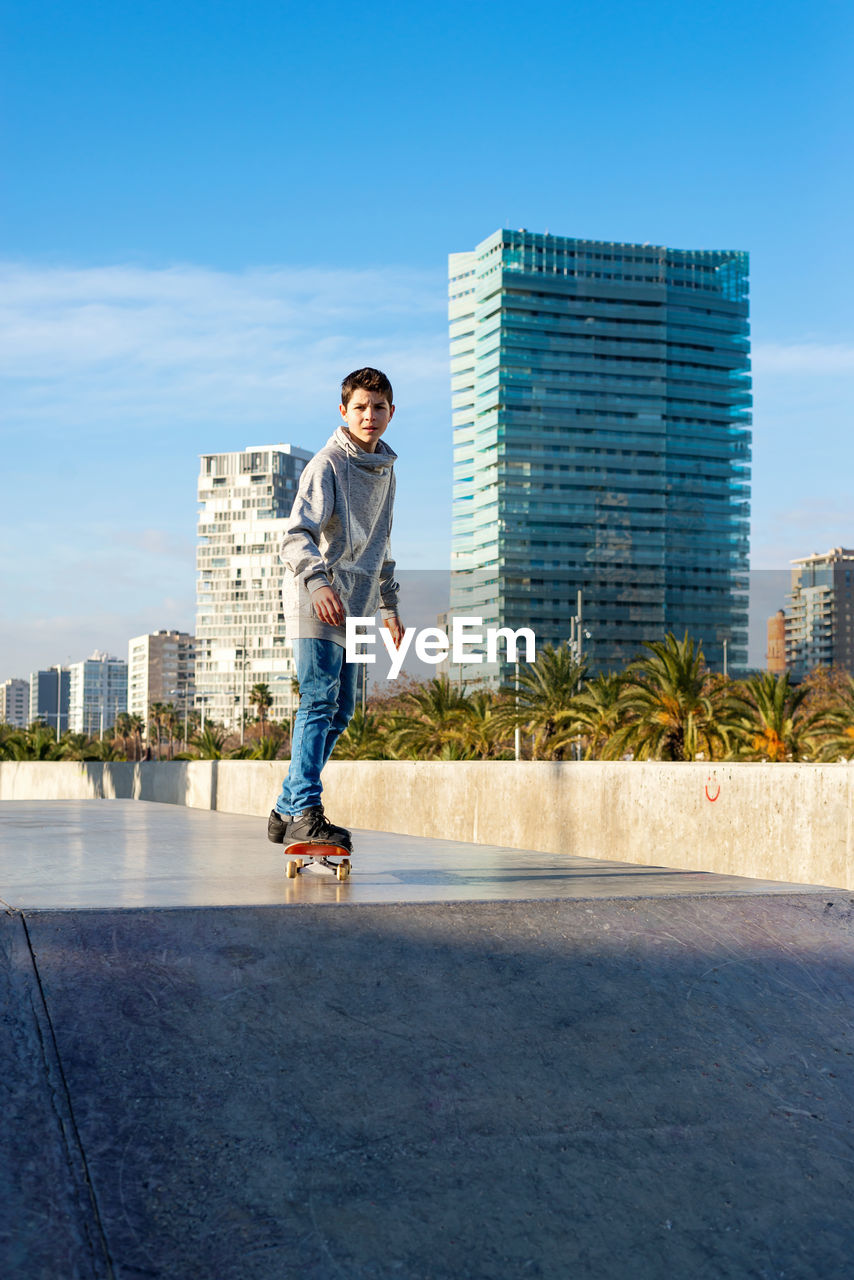 Young skater teen riding on skate ramp