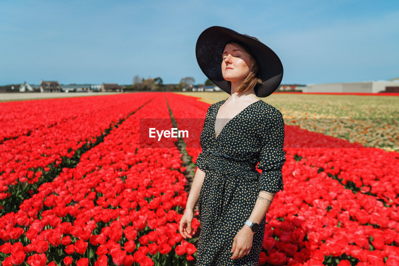 Woman standing on tulip field