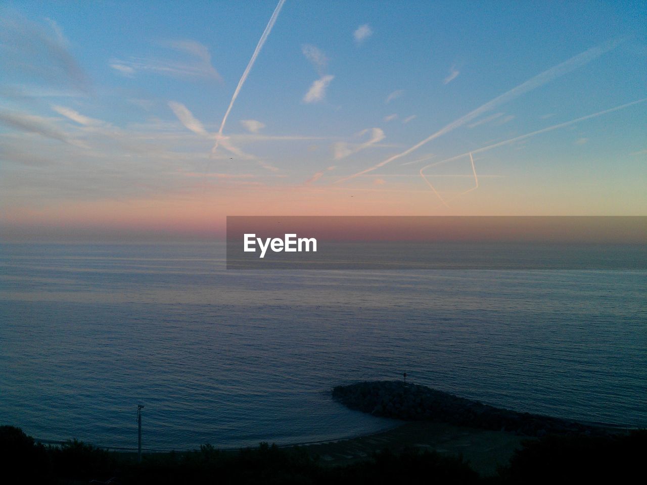 Scenic view of sea against sky at sunset