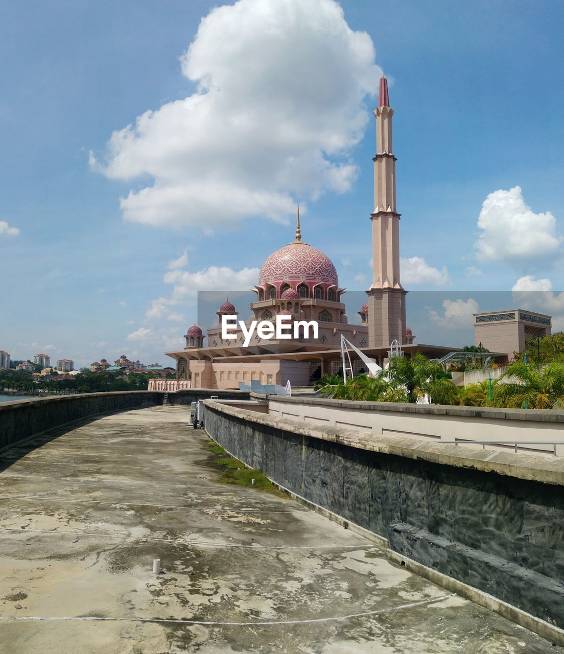 Footpath leading towards putra mosque against sky