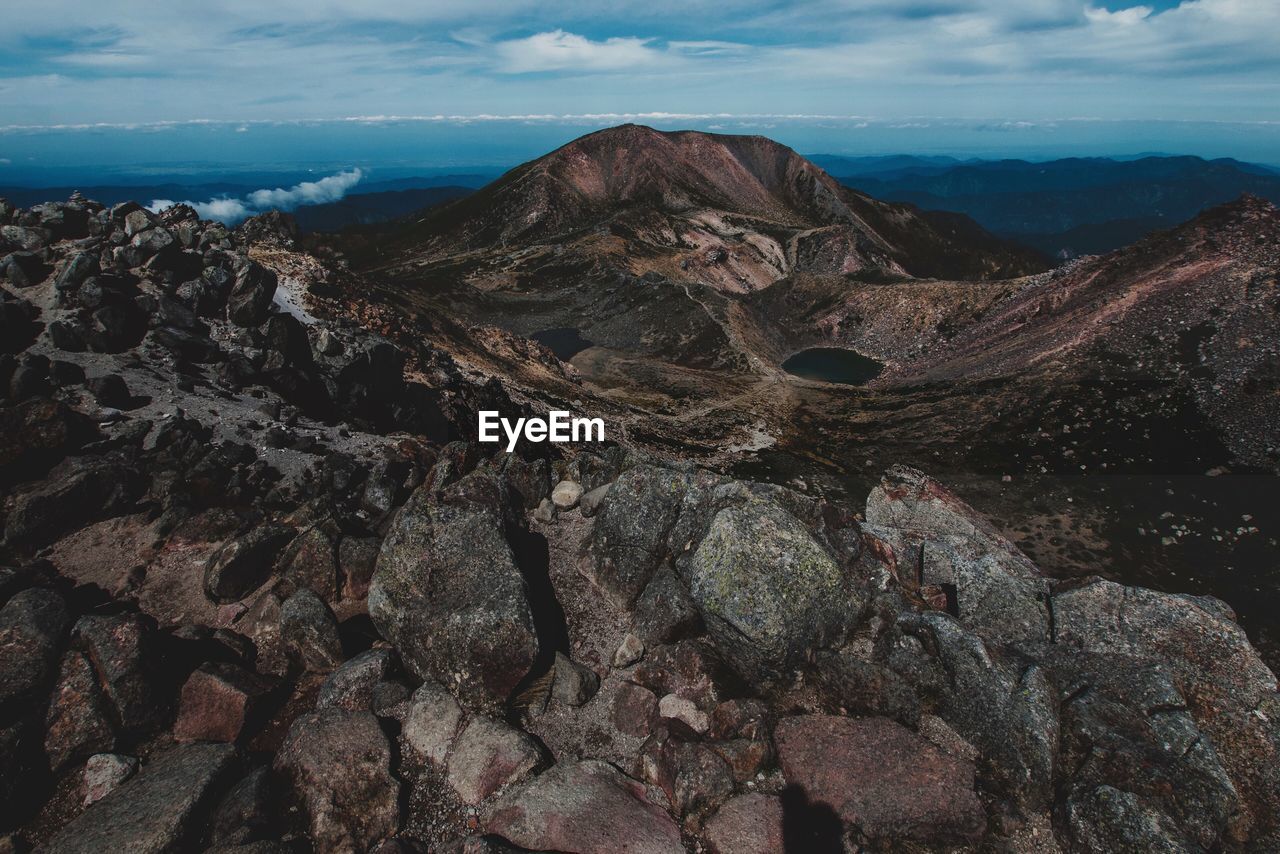 Aerial view of sea and mountains against sky