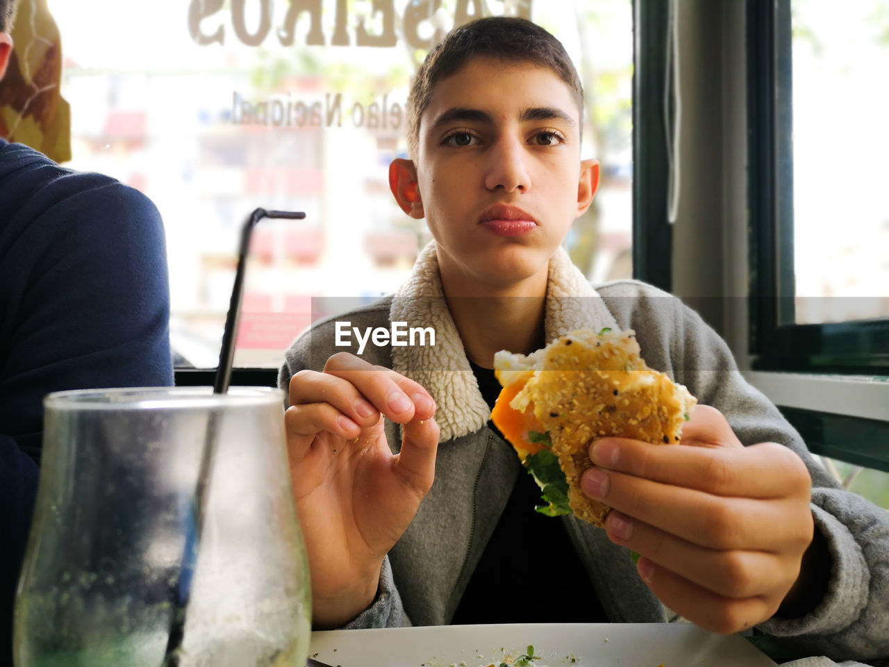 Portrait of men eating food in restaurant