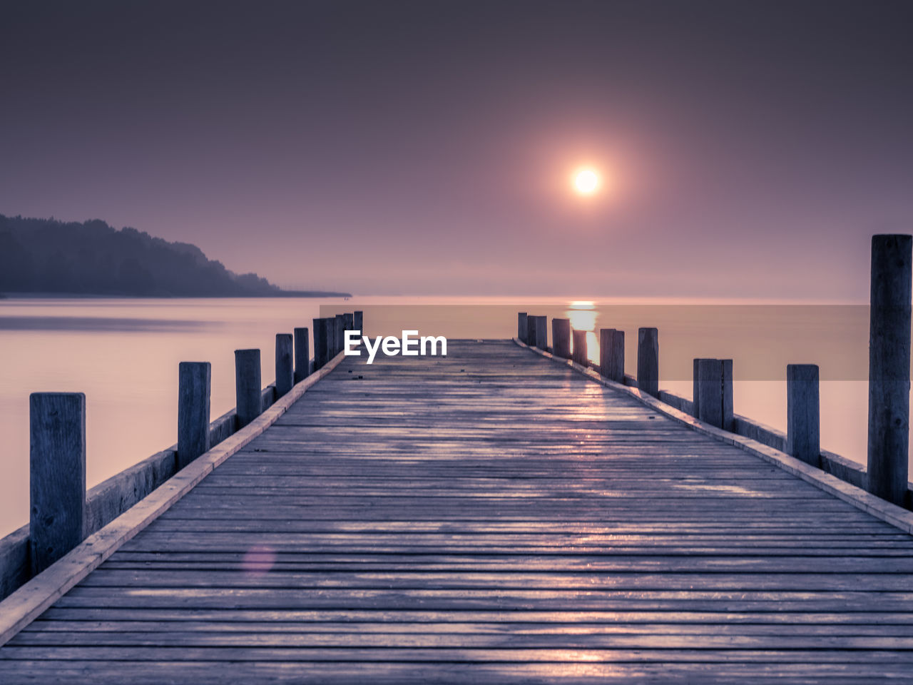 PIER ON SEA AGAINST SKY DURING SUNSET