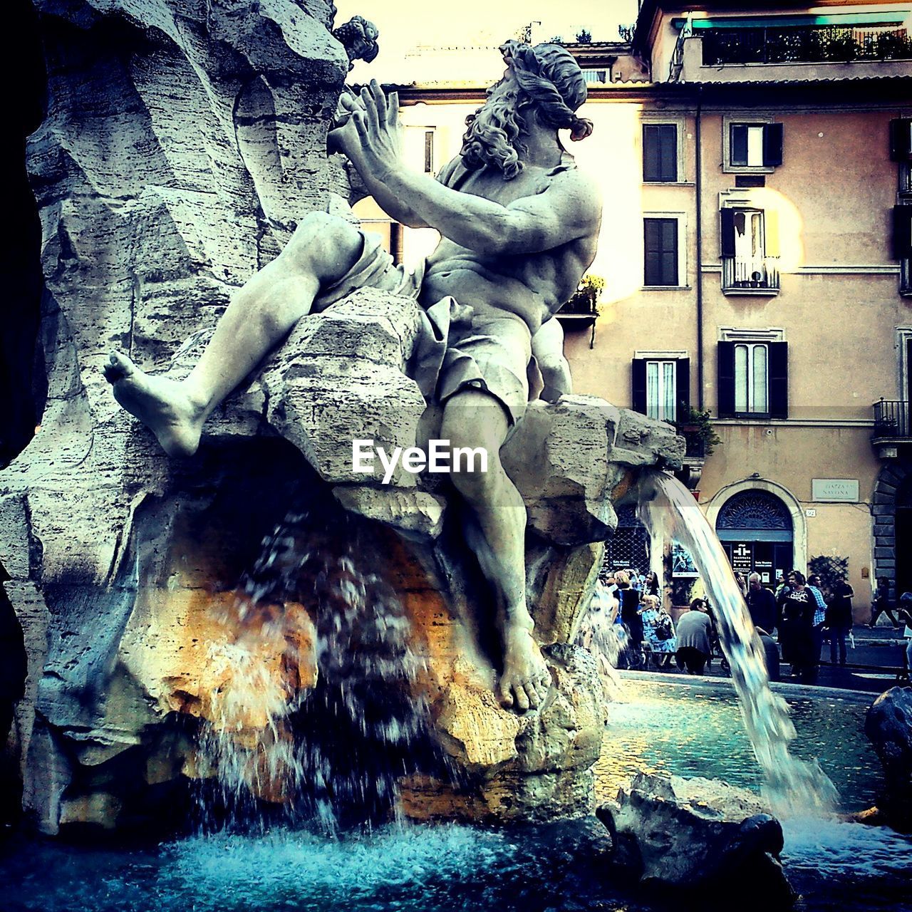 Close-up of sculpture on water fountain against building