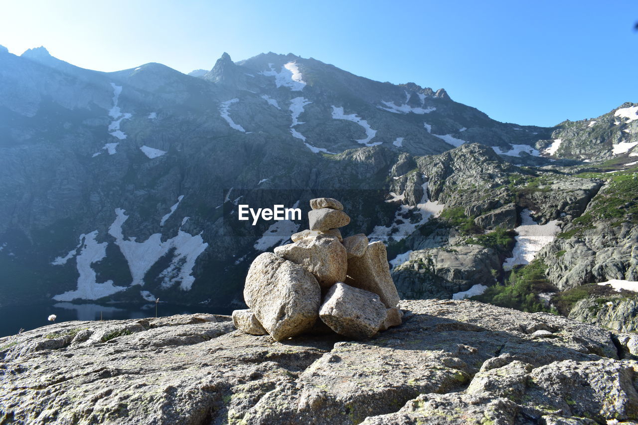 VIEW OF ROCKS AND MOUNTAINS AGAINST SKY