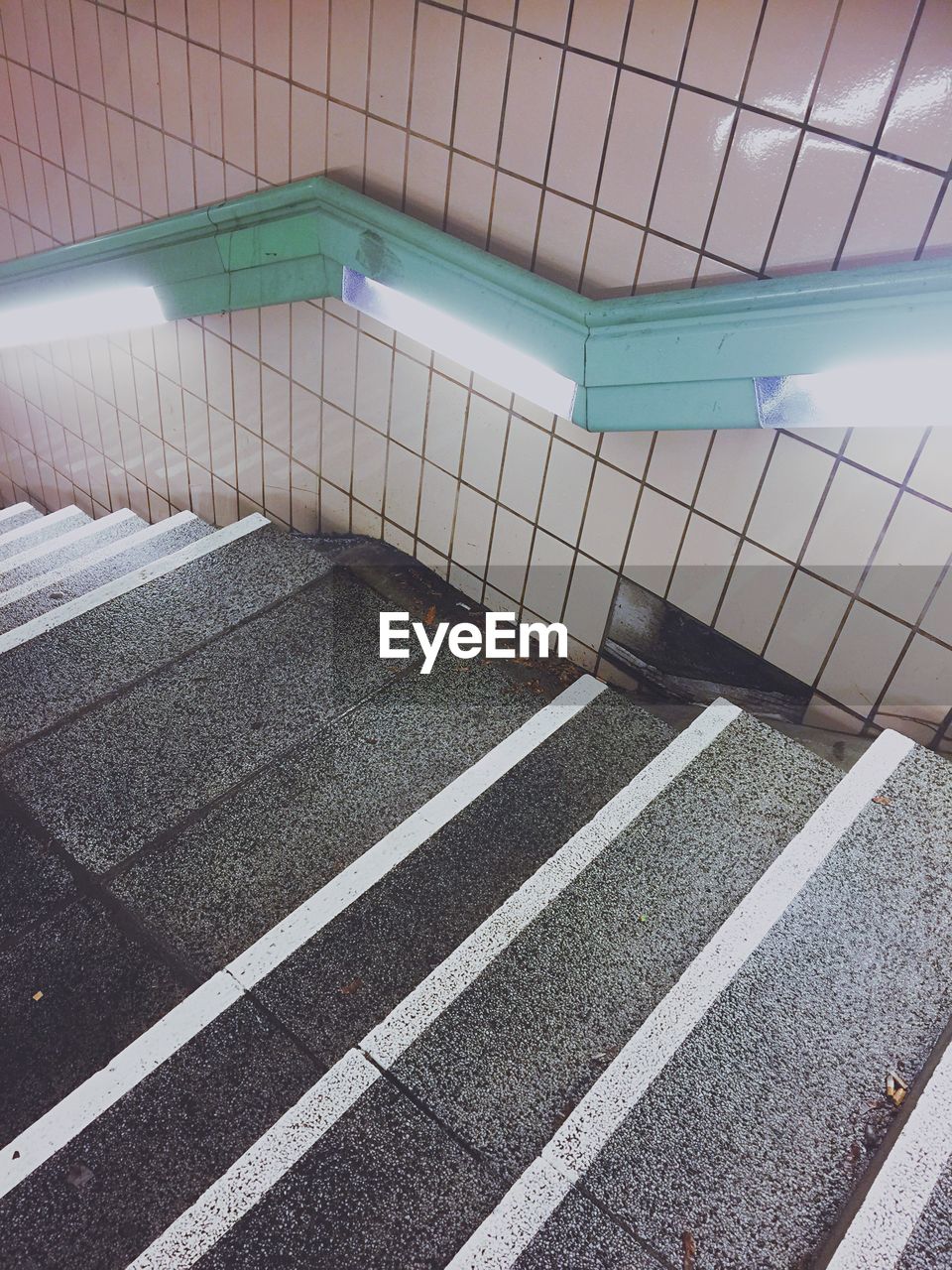 CLOSE-UP OF TILED FLOOR IN ILLUMINATED UNDERGROUND