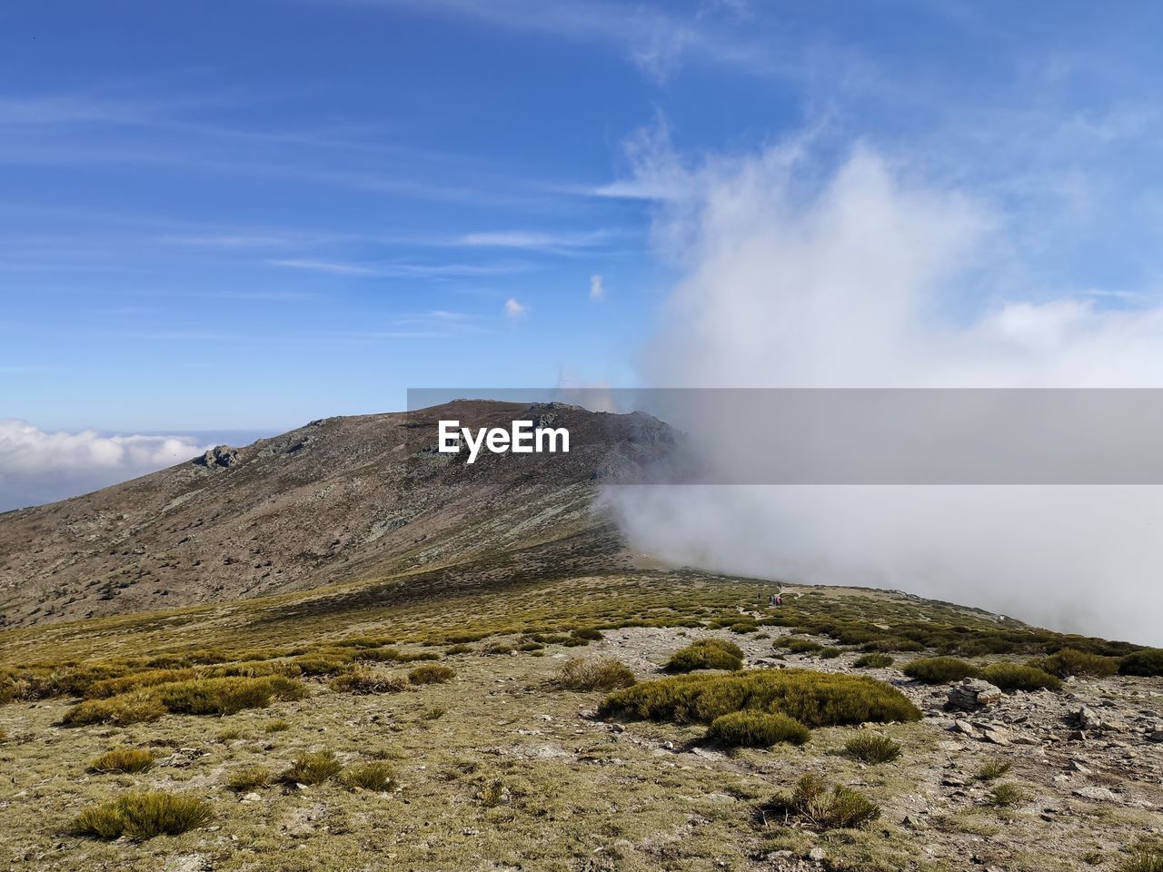 Rolling fog on mountain peak 