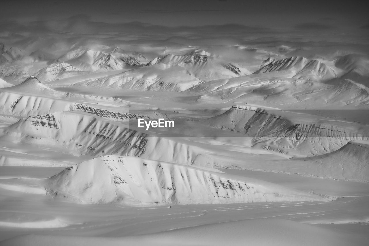 Aerial view of snowcapped mountains against sky