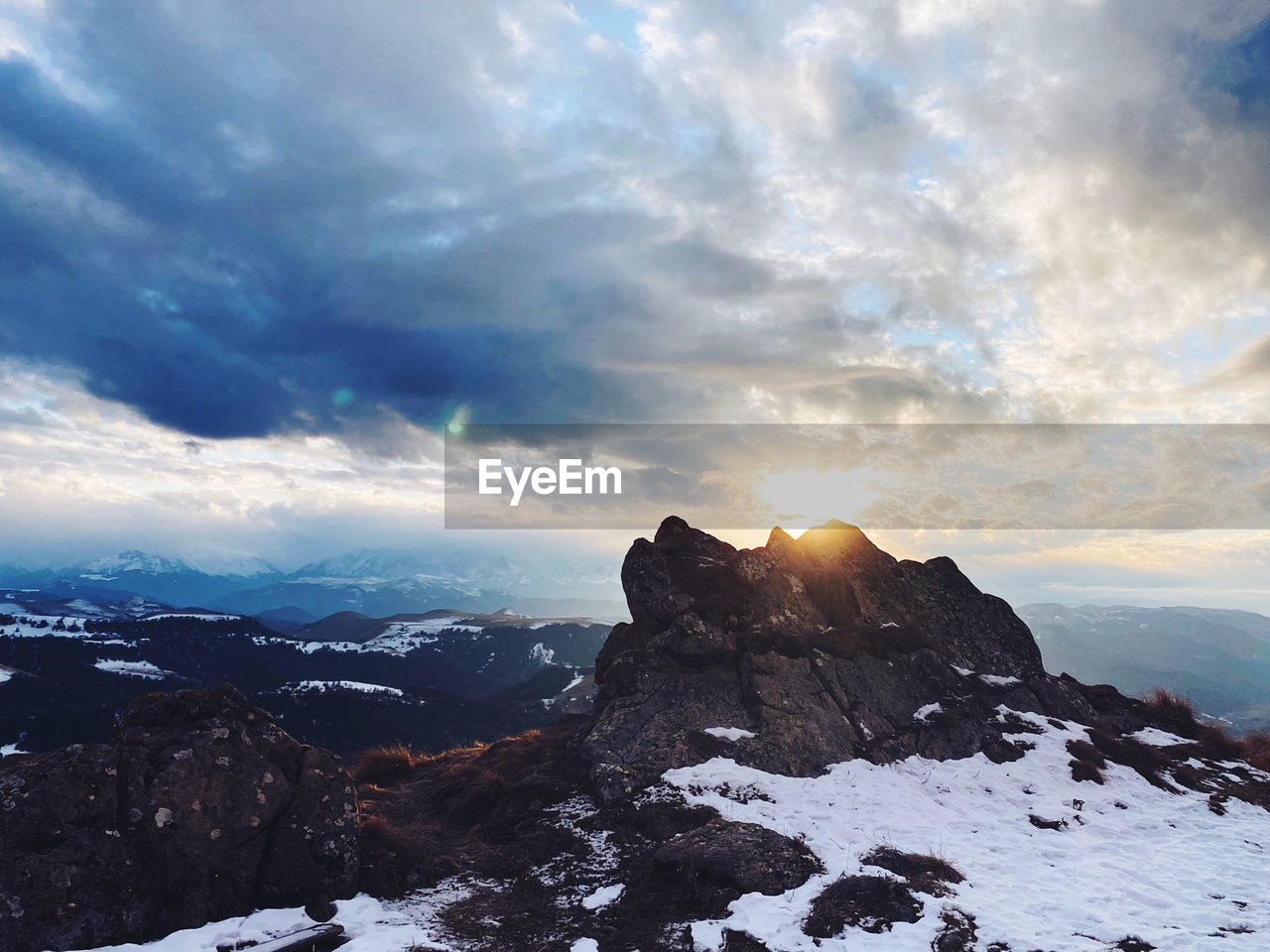 SCENIC VIEW OF SNOWCAPPED MOUNTAINS DURING SUNSET