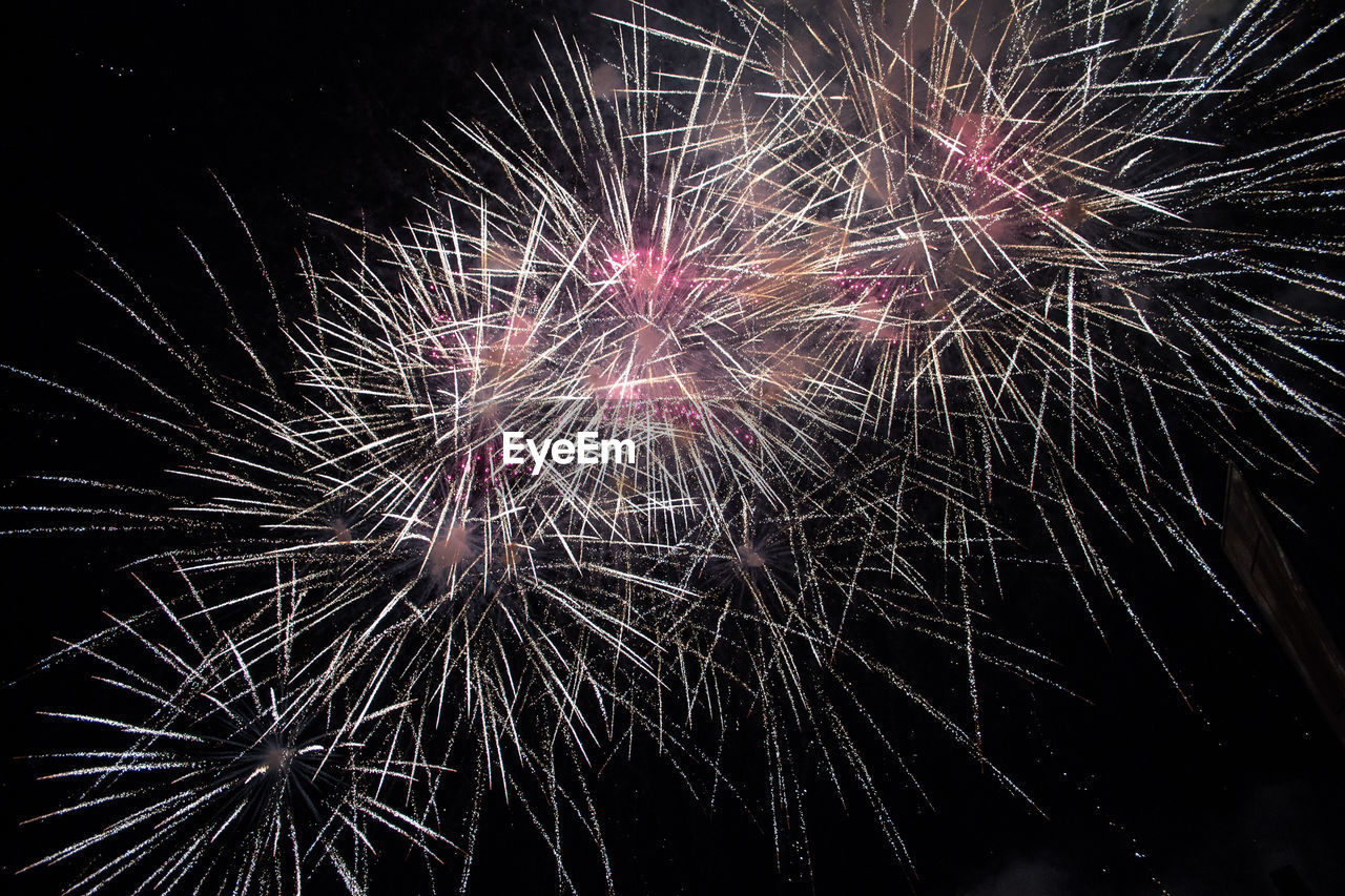 LOW ANGLE VIEW OF FIREWORK DISPLAY IN SKY