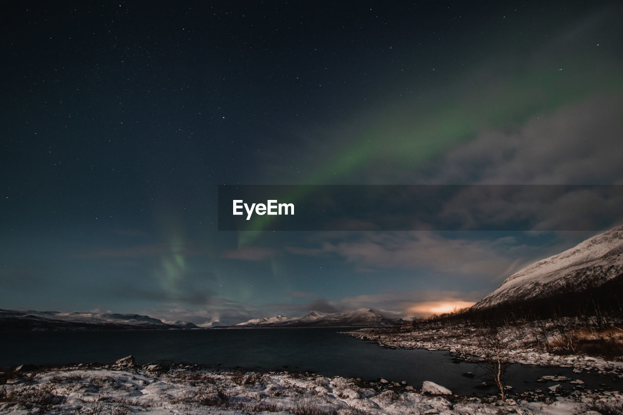 SCENIC VIEW OF SKY OVER WATER AT NIGHT