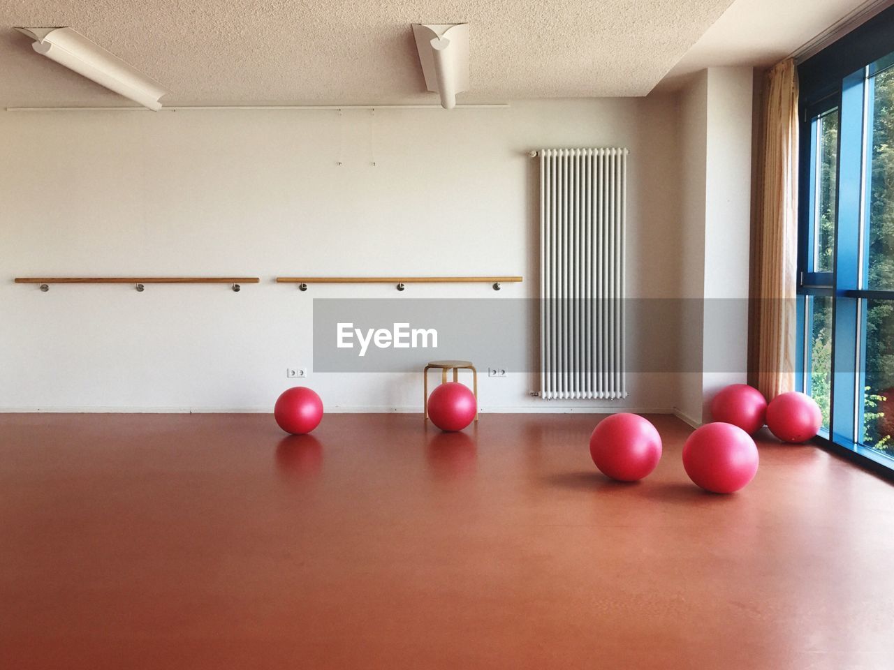 Fitness balls on hardwood floor in gym