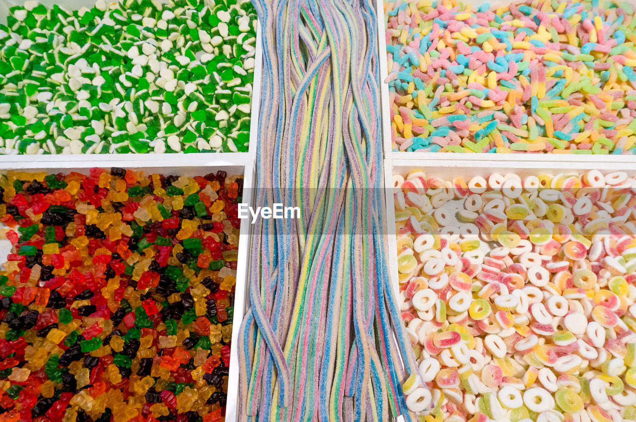 HIGH ANGLE VIEW OF MULTI COLORED CANDIES FOR SALE AT MARKET STALL