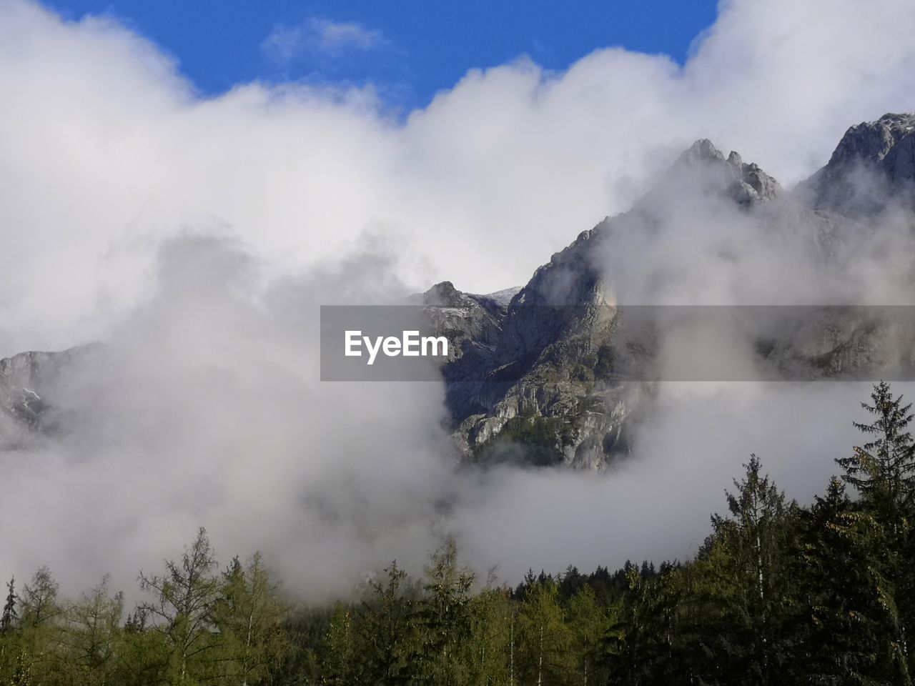 SCENIC VIEW OF CLOUDS OVER MOUNTAIN