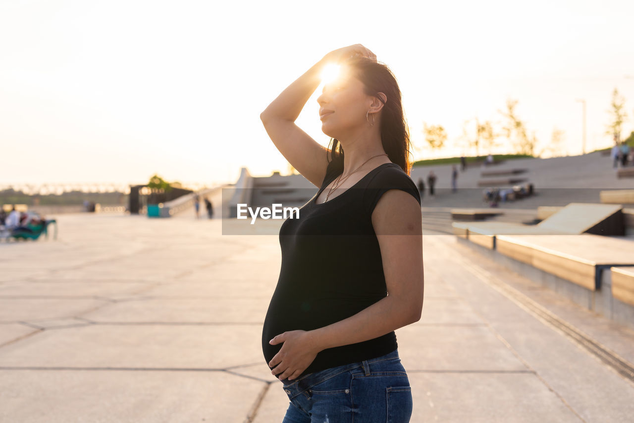 Pregnant woman standing outdoors