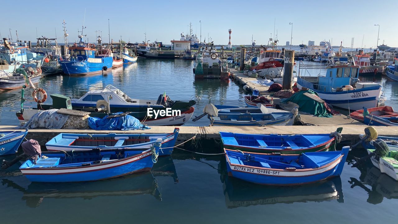 BOATS MOORED IN MARINA