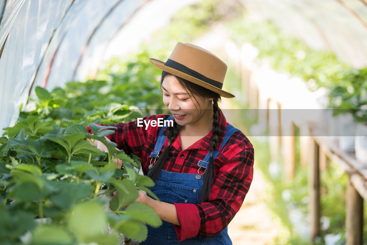 Young woman working at greenhouse