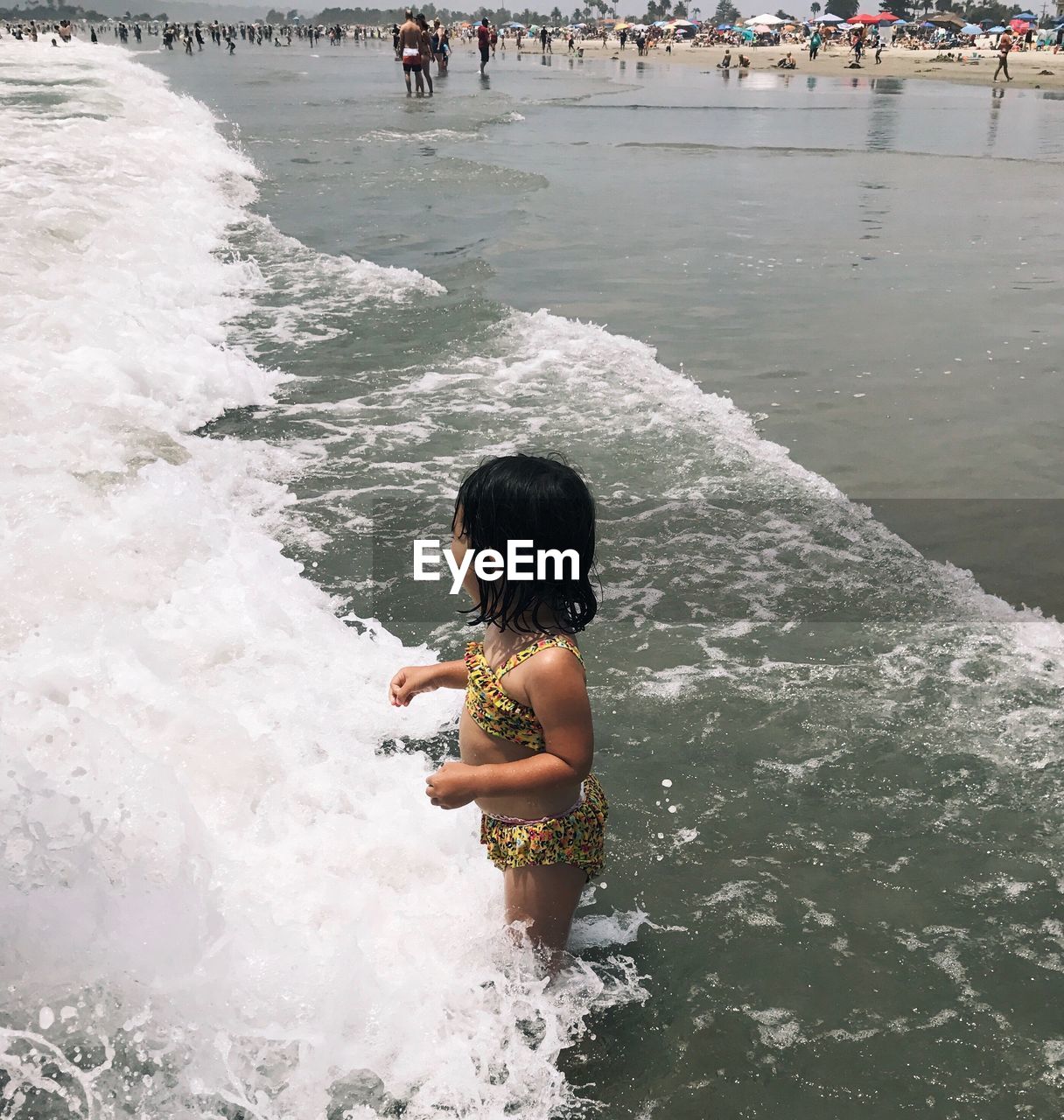 HIGH ANGLE VIEW OF BOY IN SEA