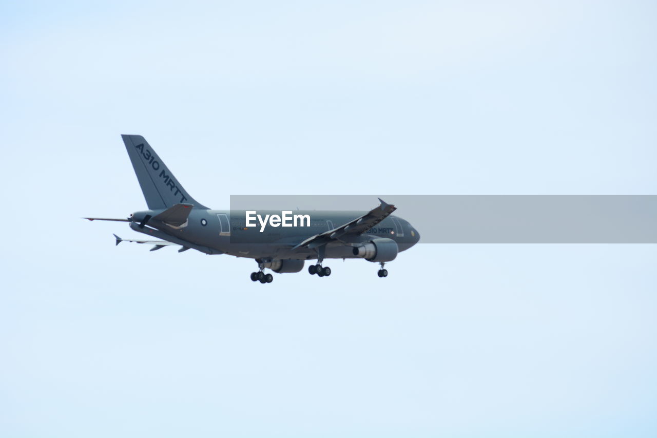 LOW ANGLE VIEW OF AIRPLANE FLYING IN SKY