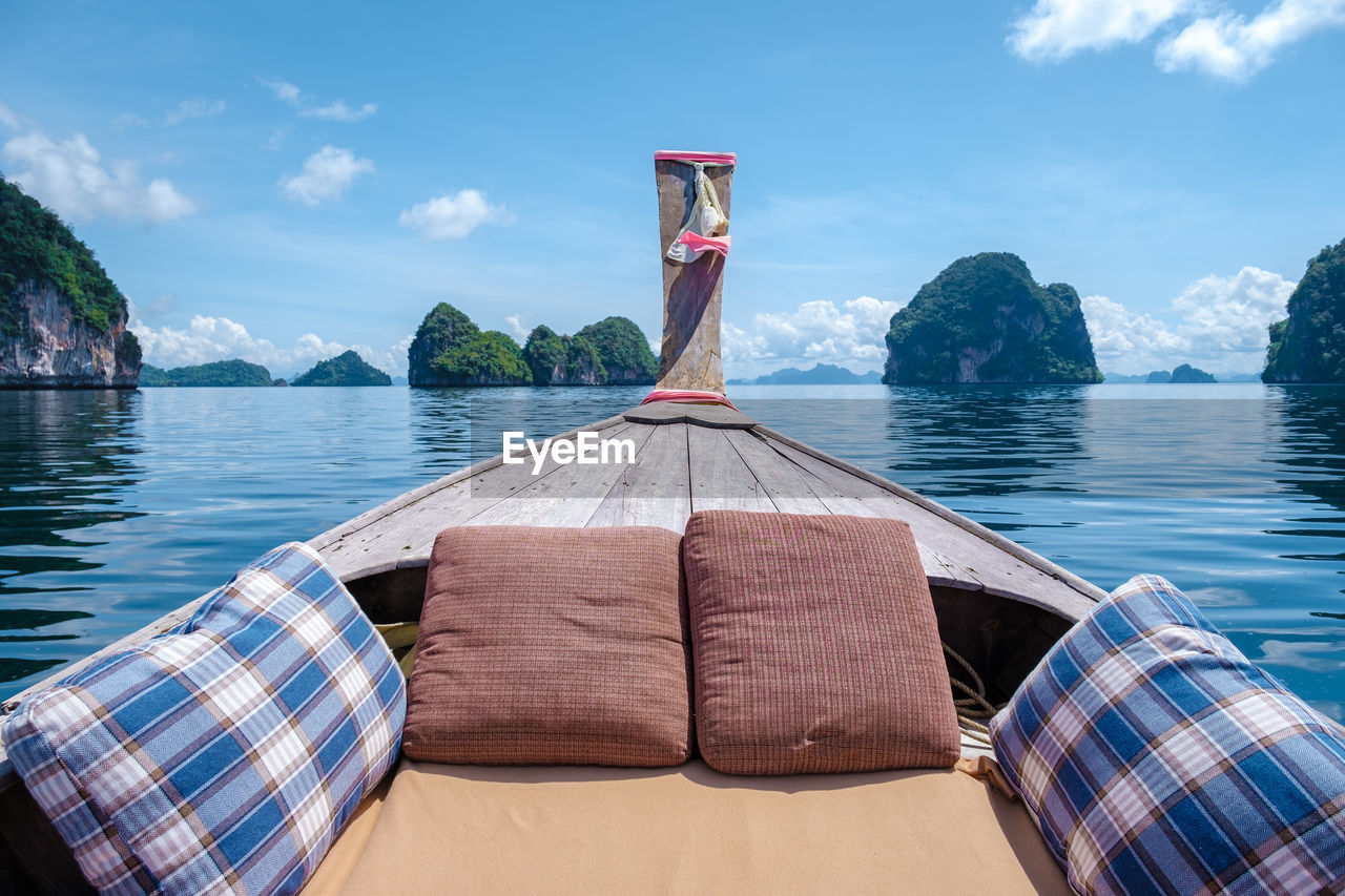 rear view of woman standing by sea