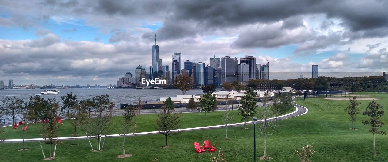 Panoramic view of buildings against cloudy sky