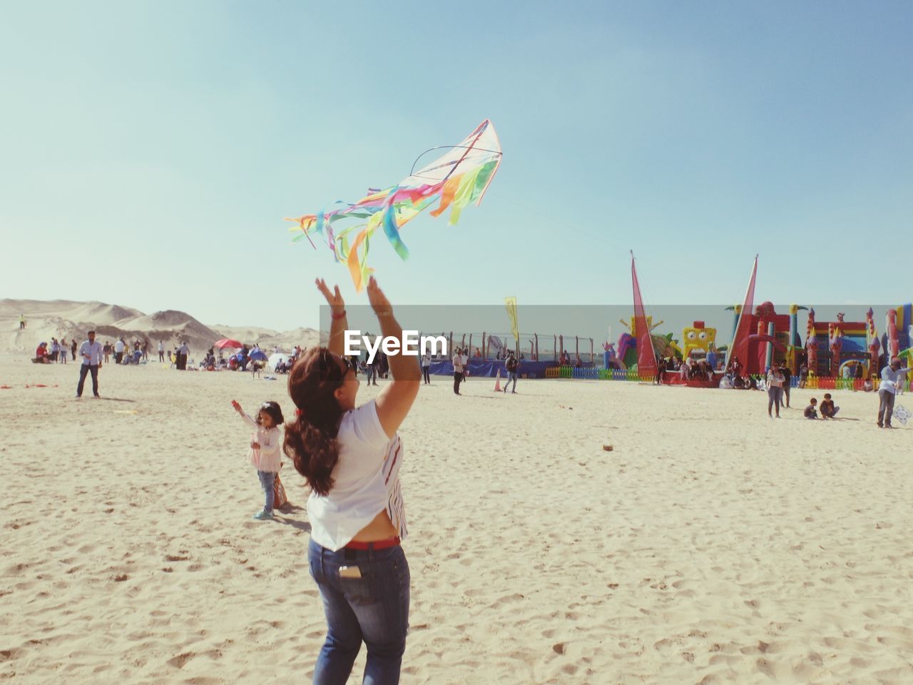 PEOPLE ON BEACH AGAINST SKY