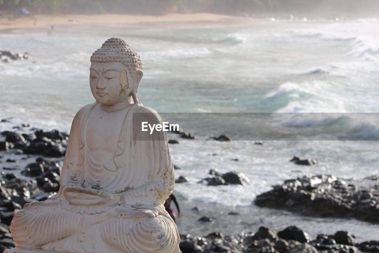Statue of buddha on beach brazil vibe 