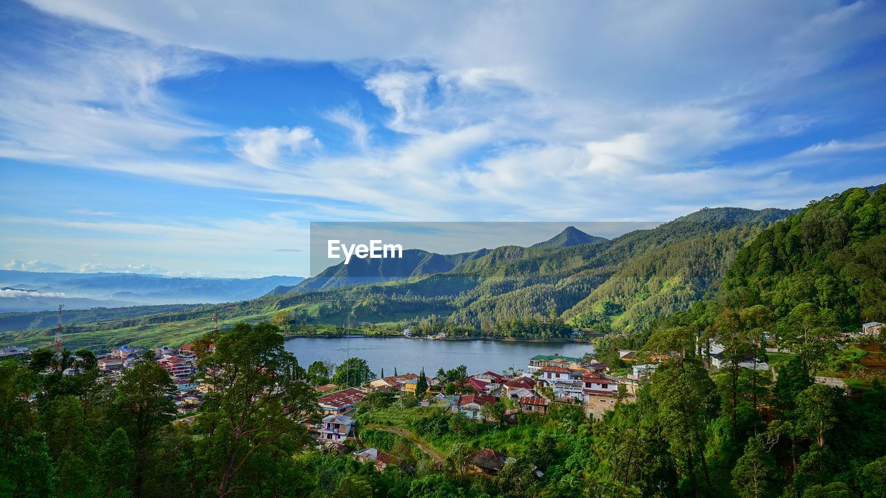 Scenic view of lake and mountains against sky