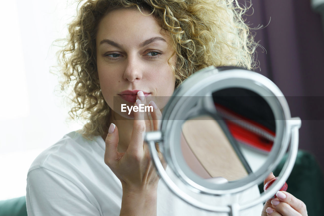 close-up of young woman looking through binoculars