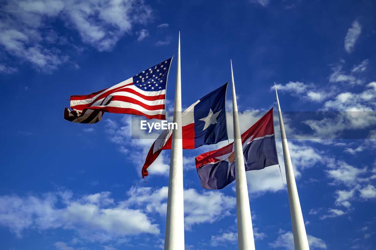 flag, patriotism, sky, blue, cloud, low angle view, wind, striped, nature, pole, environment, red, day, no people, emotion, independence, symbol, pride, outdoors, national icon, symbolism, sunlight, star shape