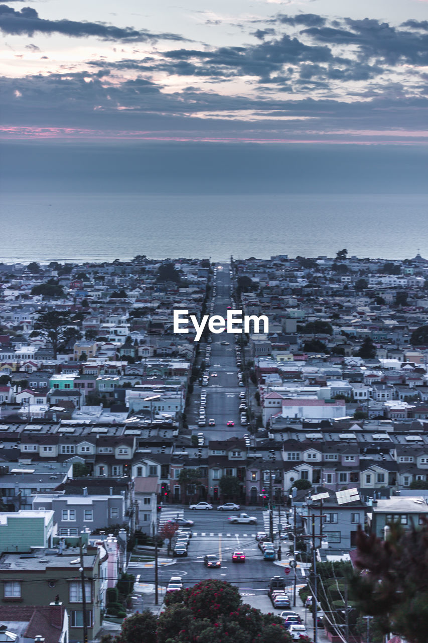 HIGH ANGLE VIEW OF CITY AT SEASIDE