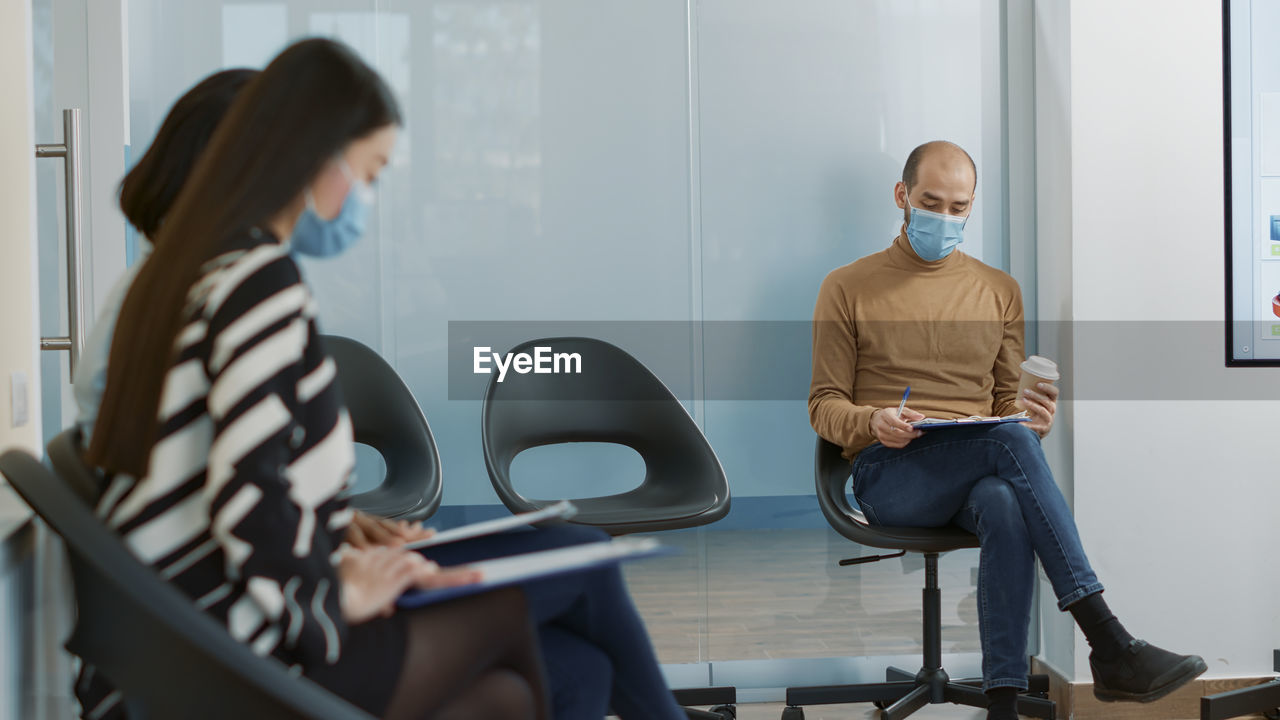 Candidates wearing mask sitting at office