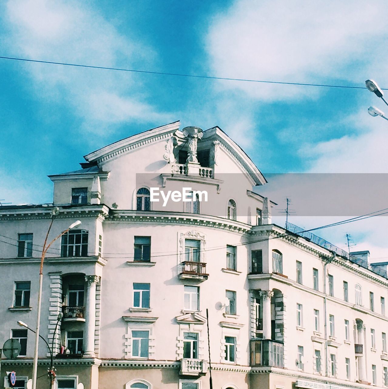 Low angle view of building against cloudy sky