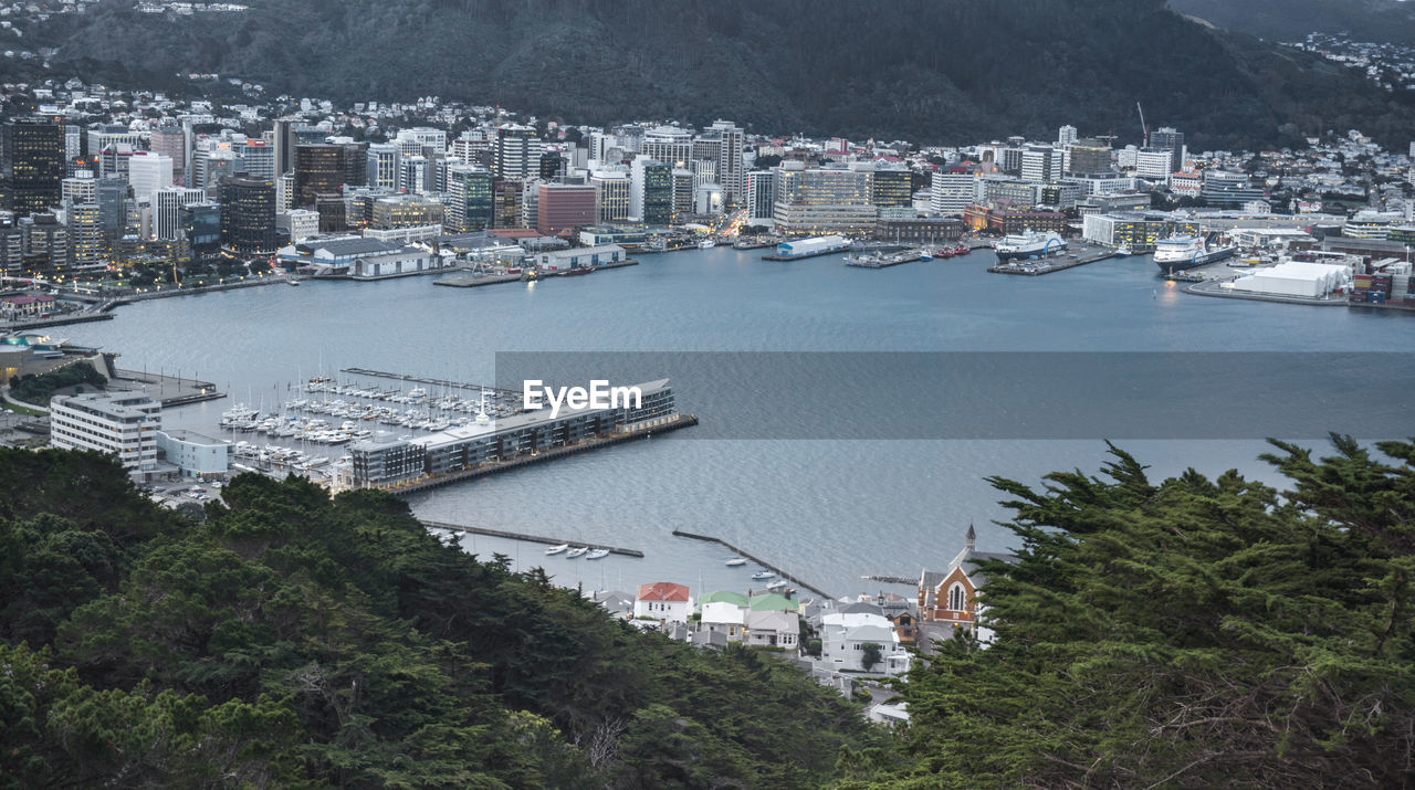 High angle view of buildings by sea in city