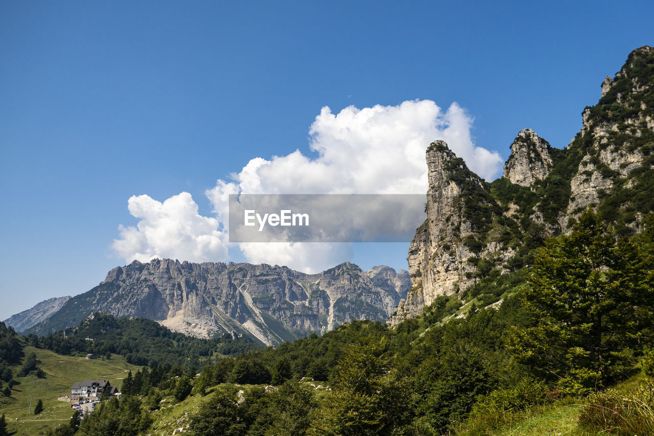 Scenic view of mountains against blue sky