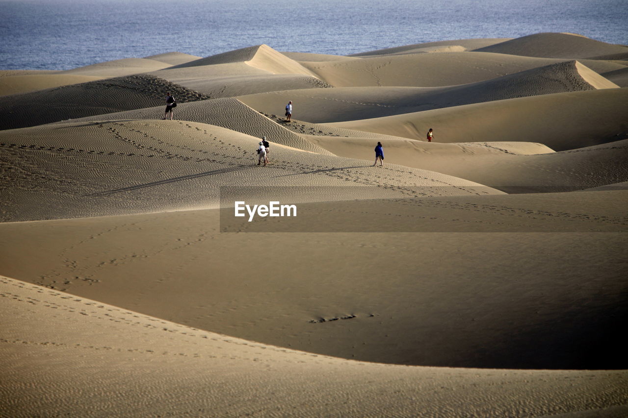 High angle view of people on desert against sea