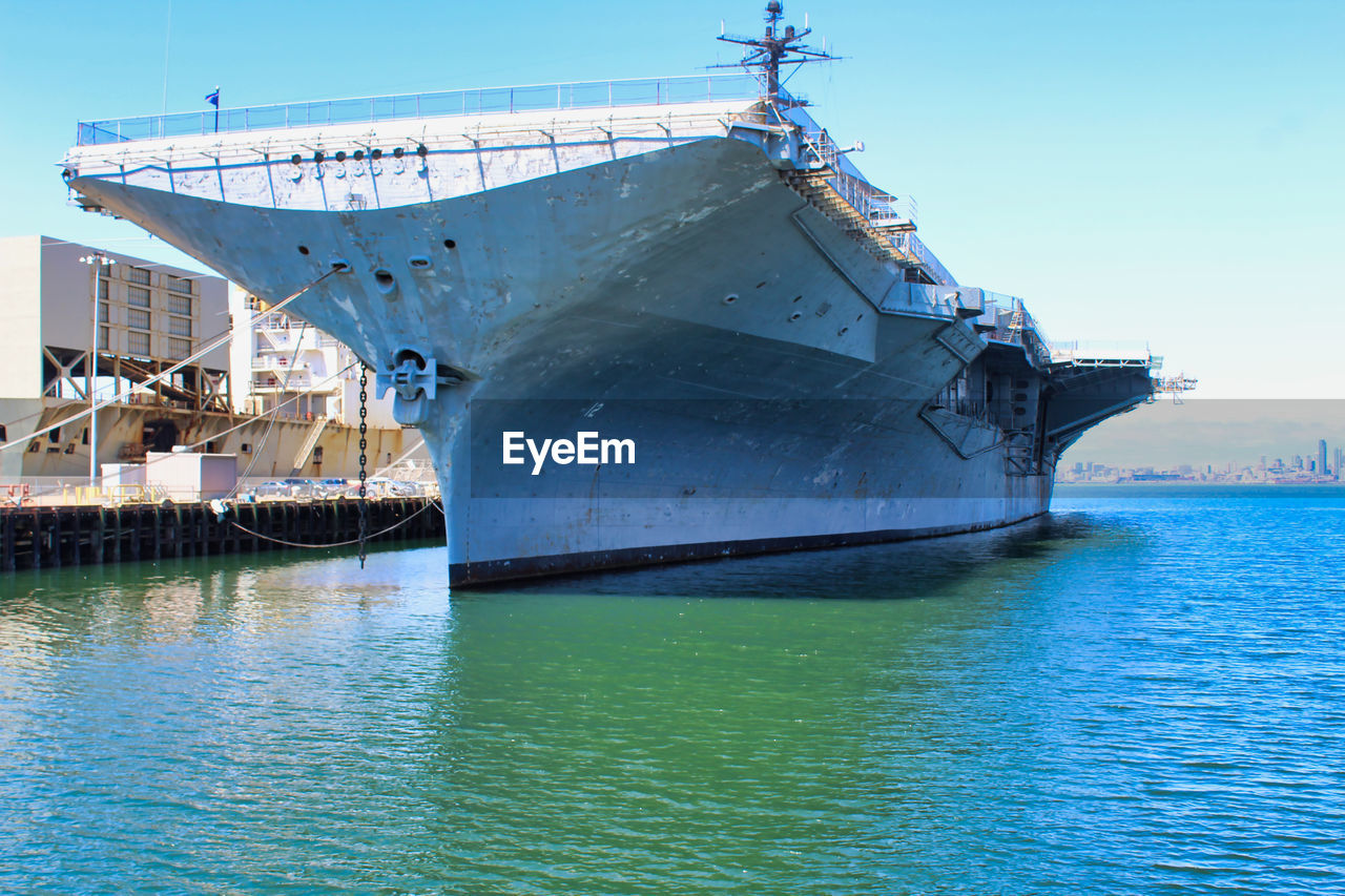 SHIP MOORED IN SEA AGAINST BLUE SKY