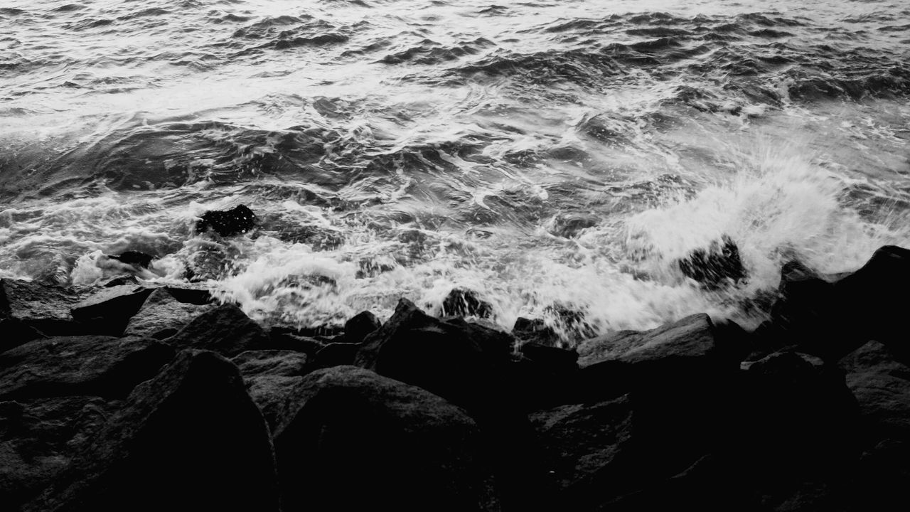 HIGH ANGLE VIEW OF WAVES ON SHORE