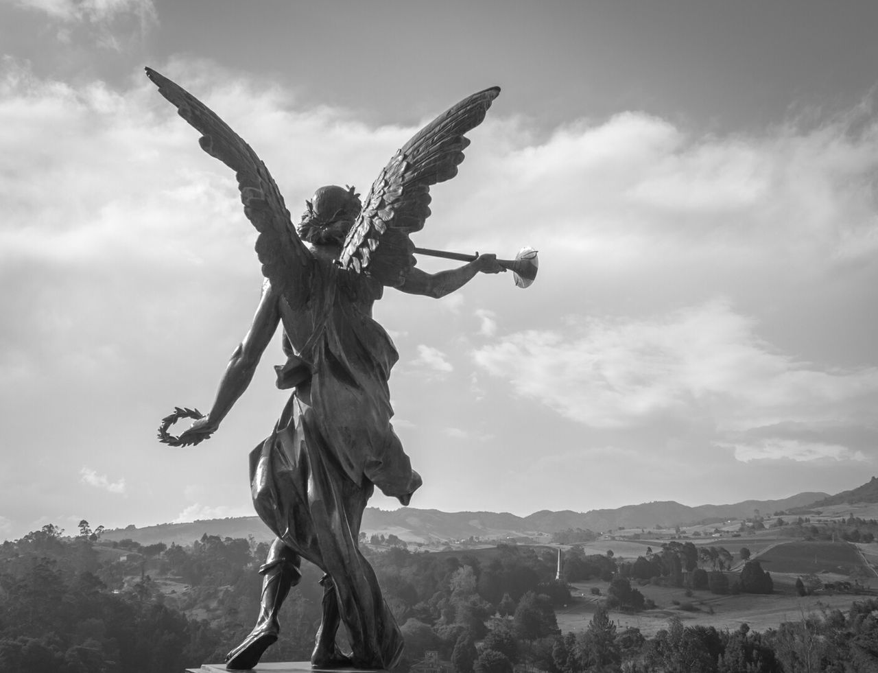 Statue of angel on pedestal