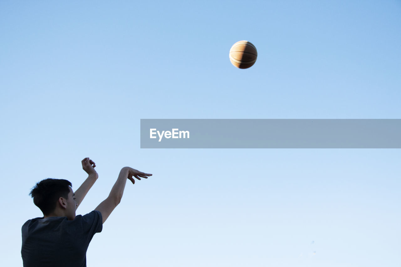 Young basketball player shooting at goal