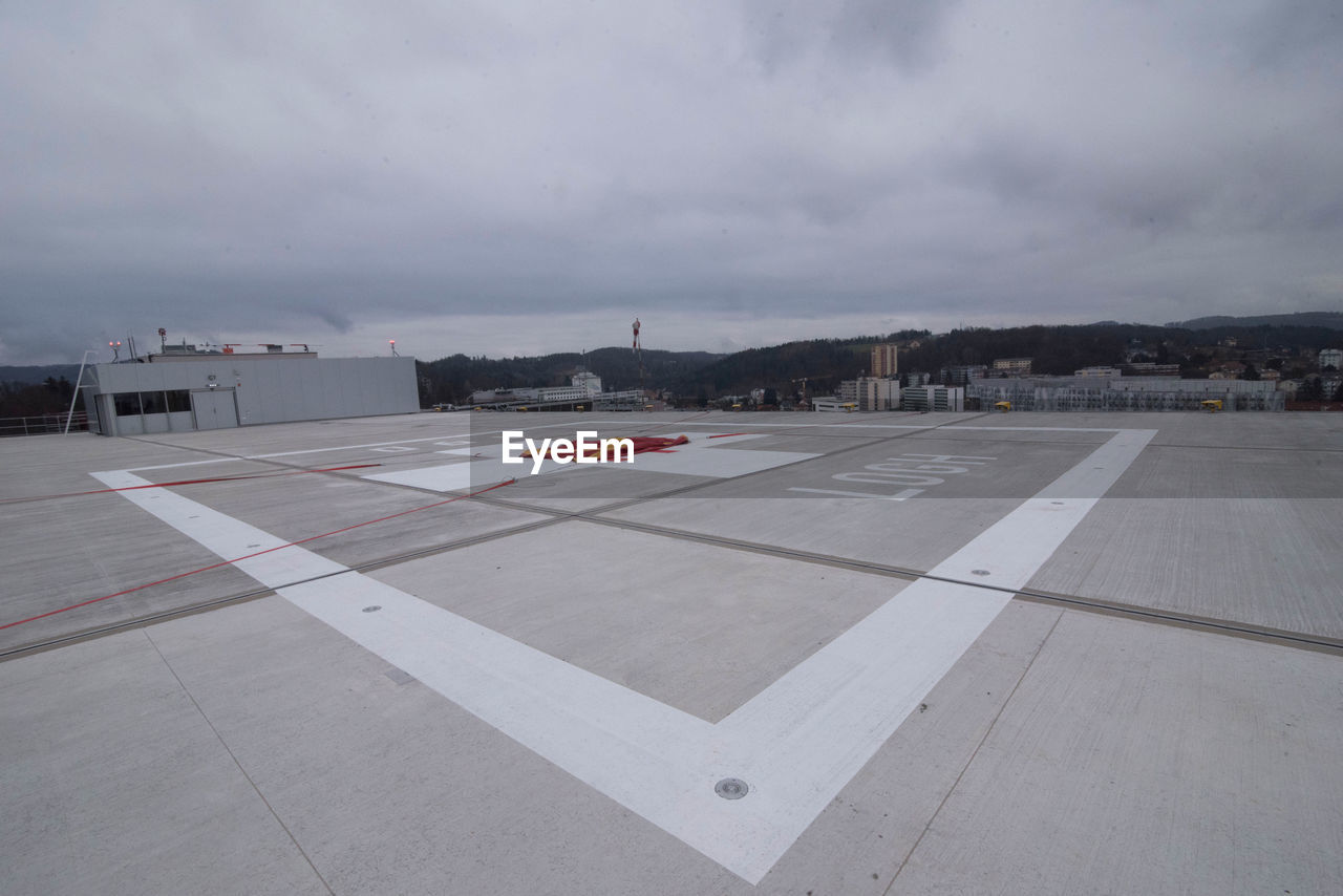 AIRPLANE ON ROAD AGAINST SKY