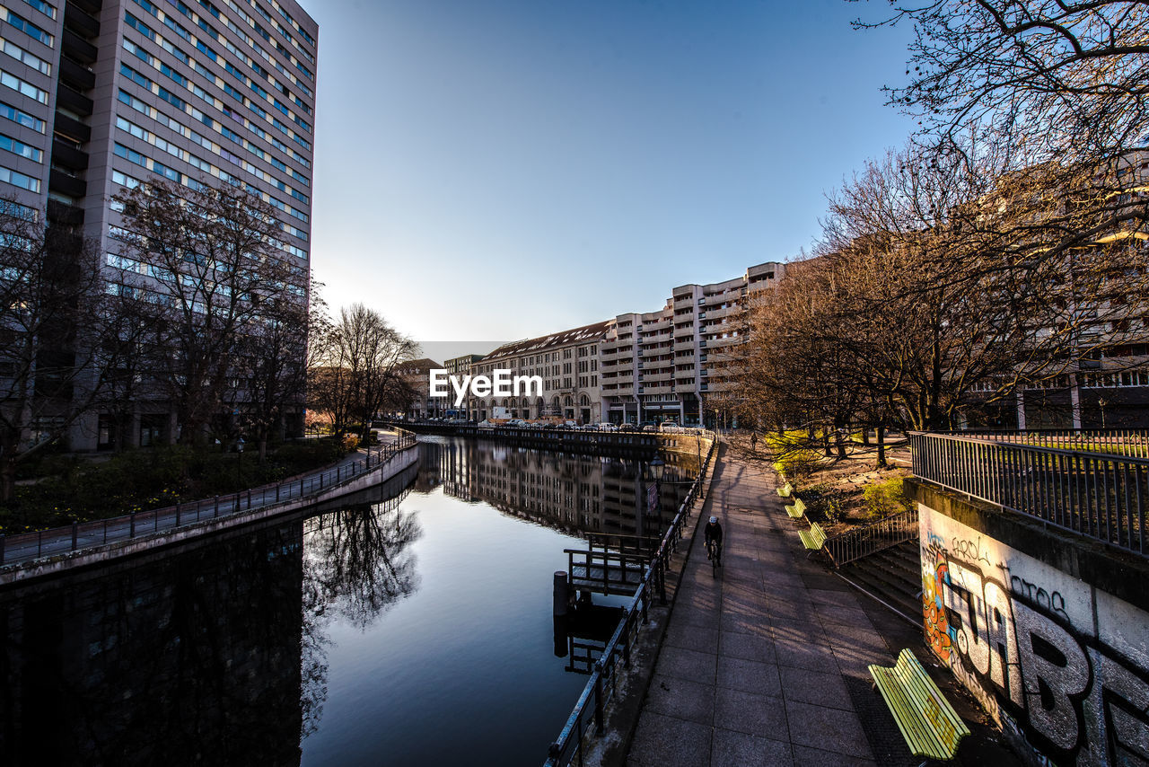 Canal amidst buildings against sky