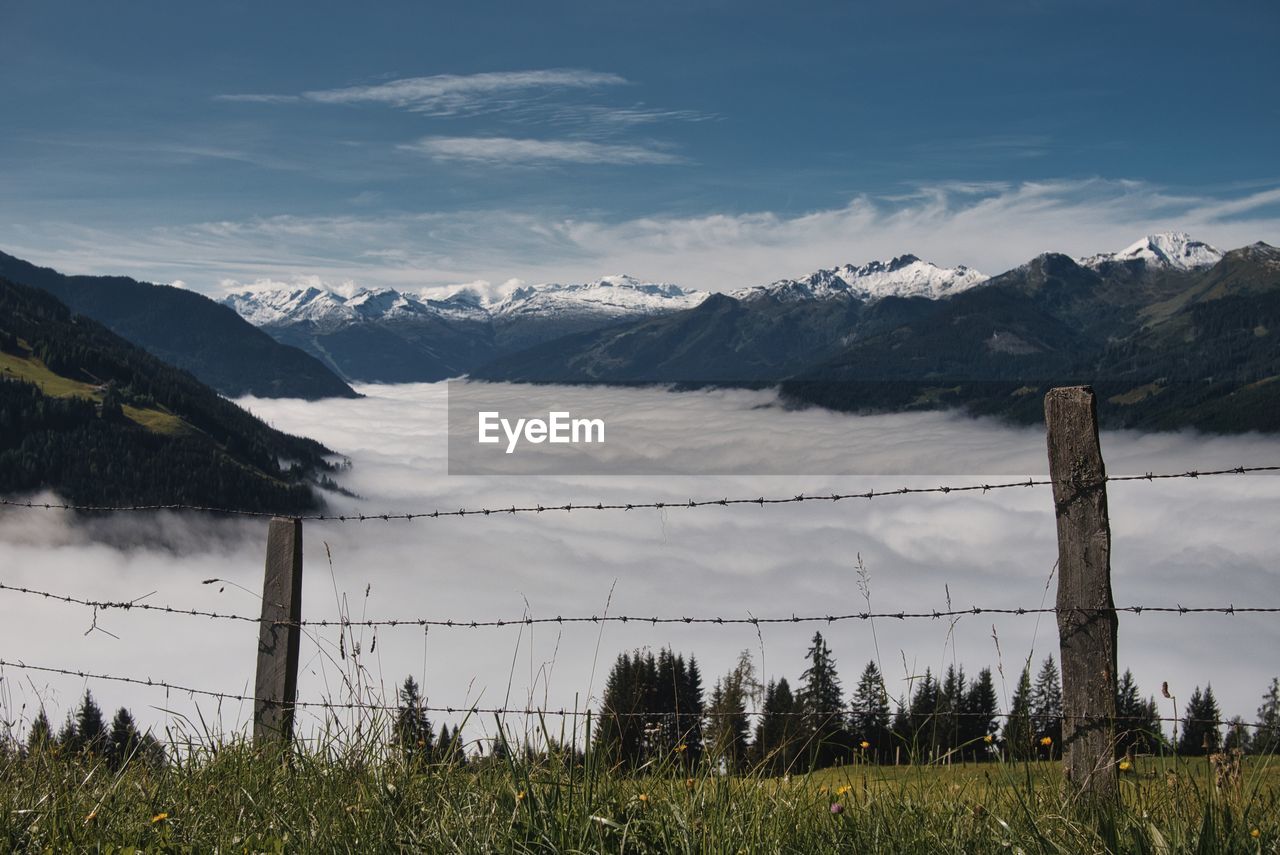 Scenic view of field against sky austria alps with a little fog