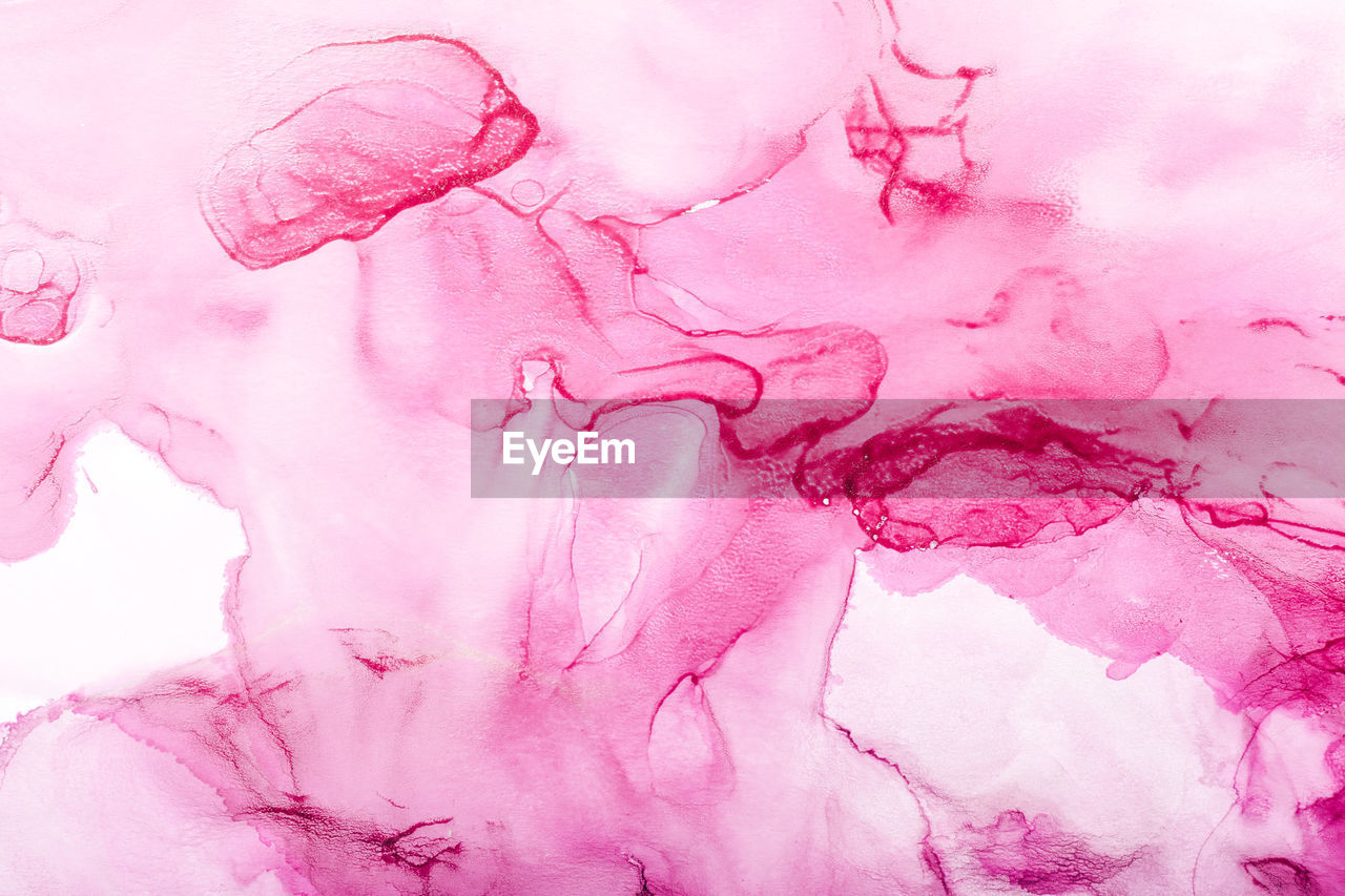 Watercolor alcohol ink swirls. transparent waves and swirls in pink magenta colors