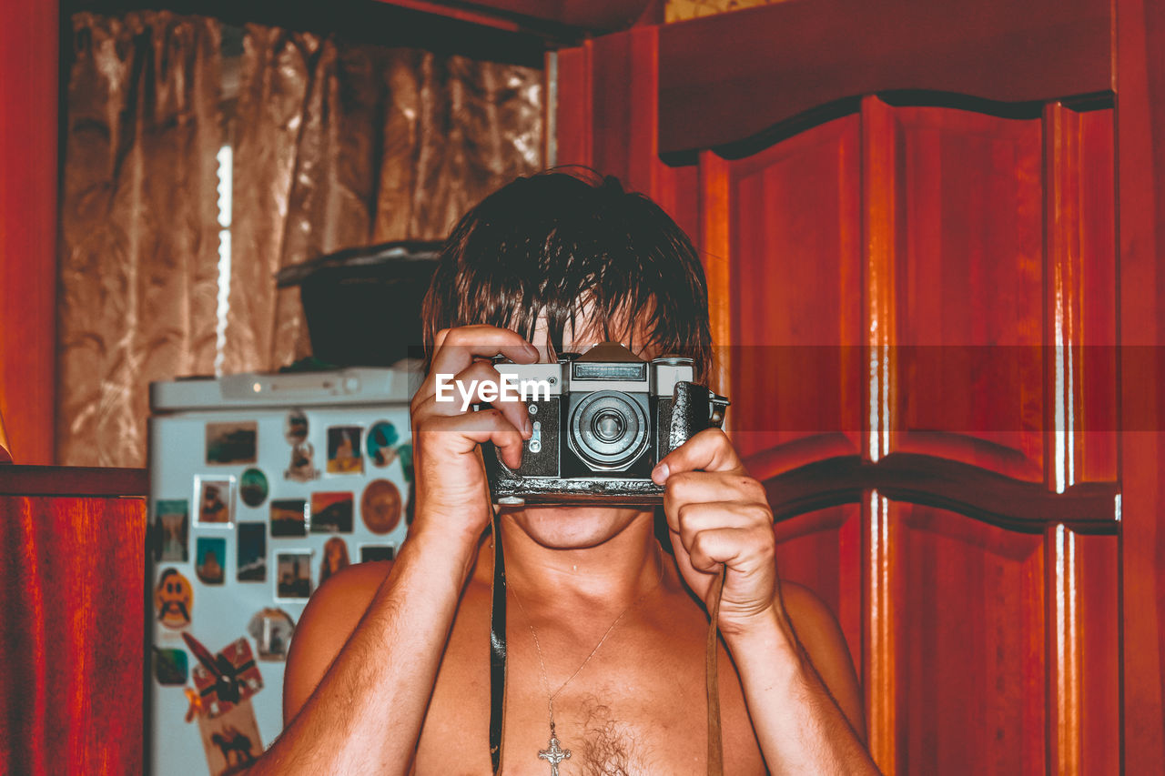 PORTRAIT OF SENIOR MAN PHOTOGRAPHING