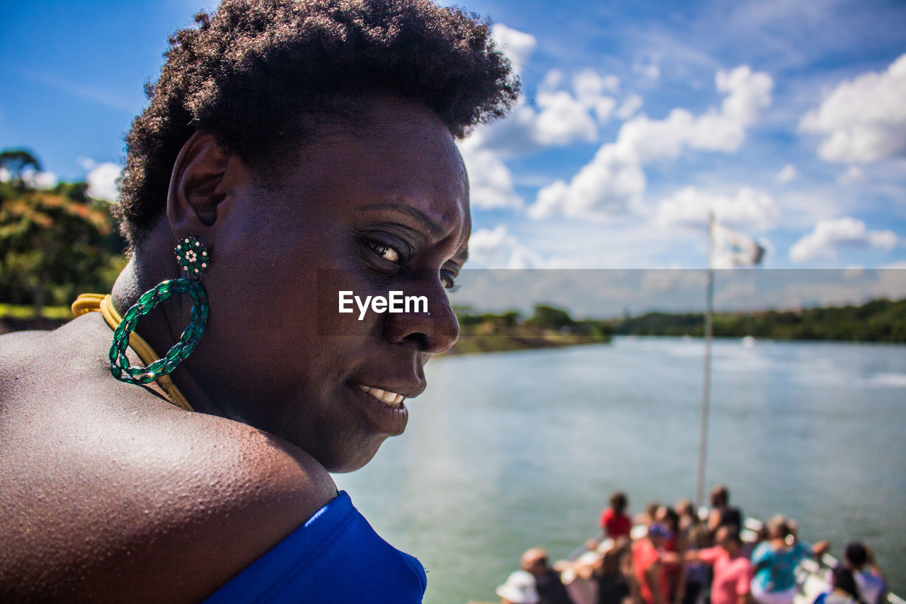 Close-up of woman looking away against sky