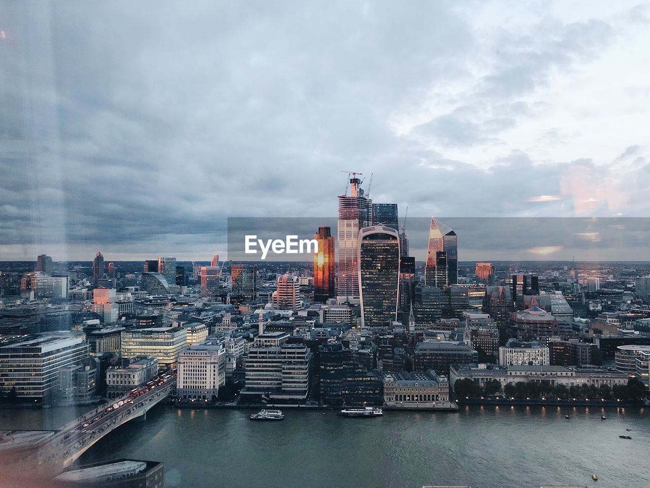 Buildings in city against cloudy sky