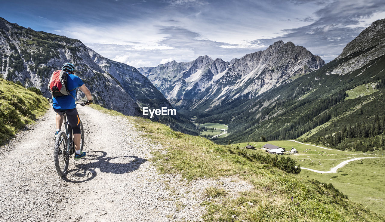 Rear view of cyclist on country road