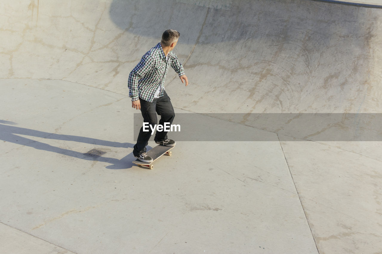 Man skateboarding on ramp in park