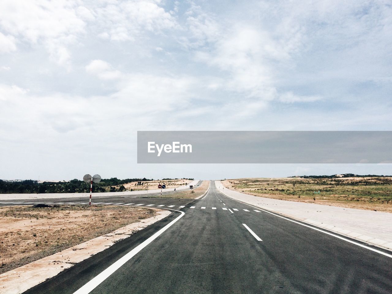 Empty road against sky